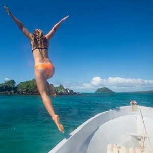 woman jumping off boat